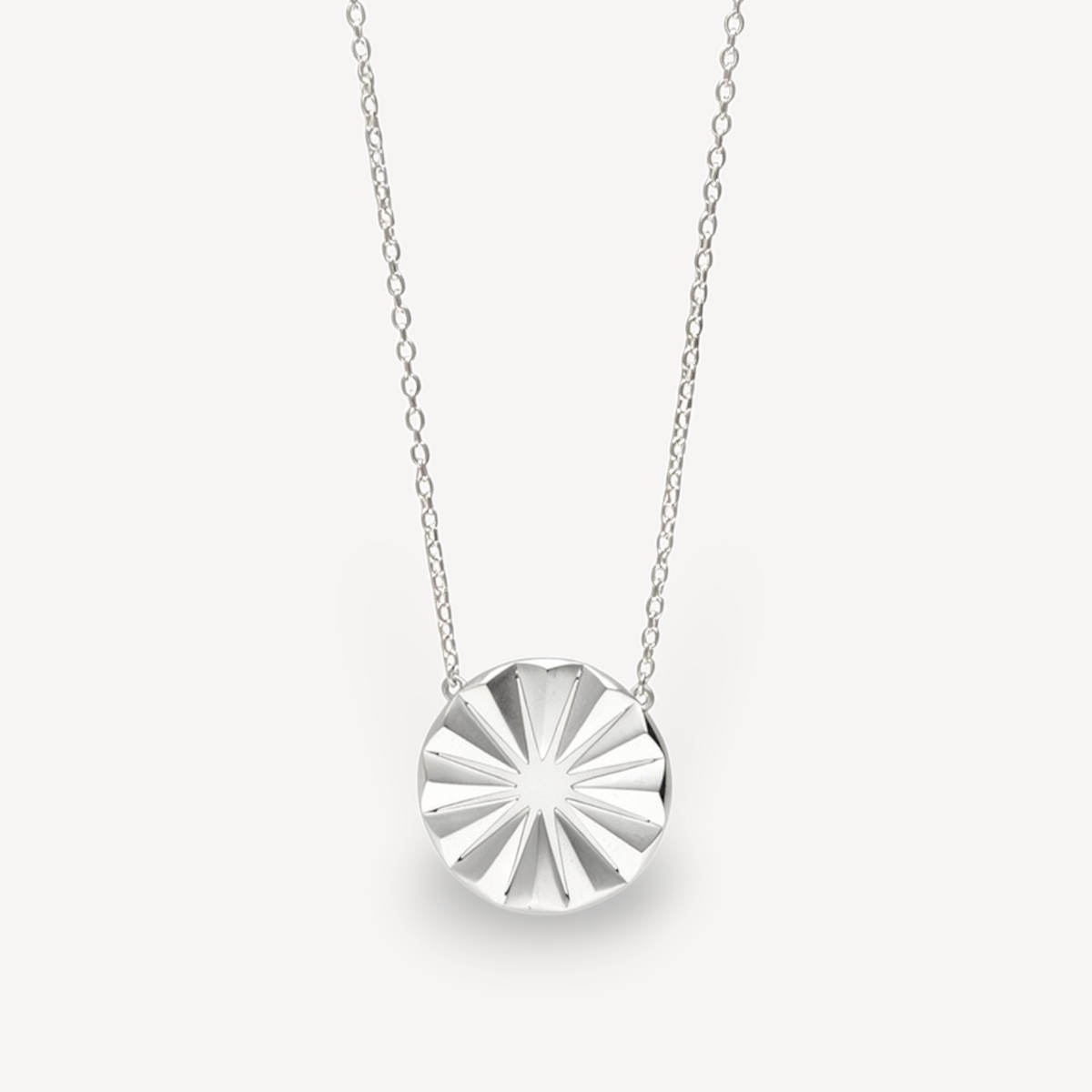 EC One Polaris Radial necklace featuring a hand-carved sterling silver circular pendant on a delicate chain.