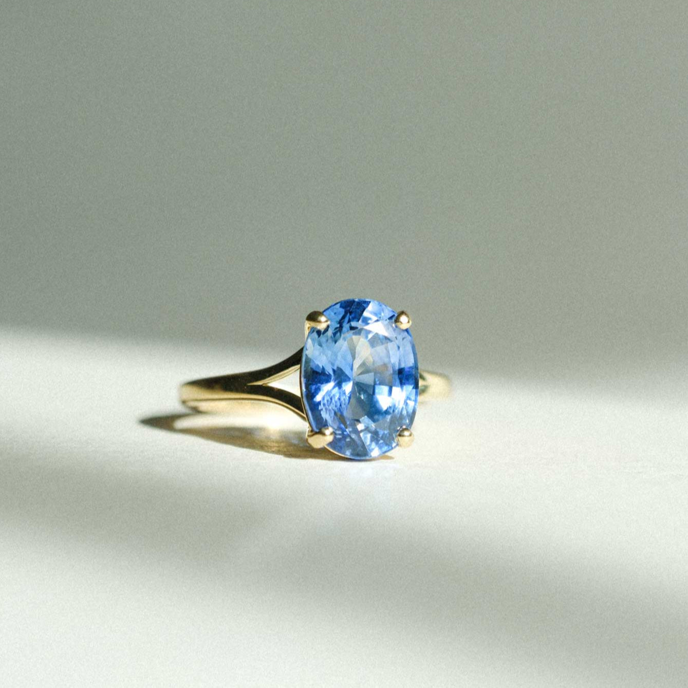 JUNO Gold Solitaire Ring with Oval Blue Sapphire made in recycled gold by ethical jeweller E.C.One London in our B Corp certified workshop