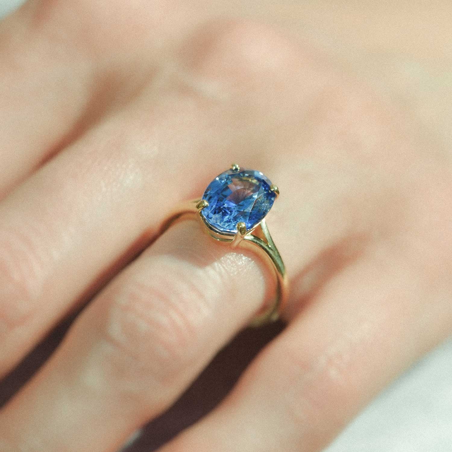 JUNO Gold Solitaire Ring with Oval Blue Sapphire made in recycled gold by ethical jeweller E.C.One London in our B Corp certified workshop