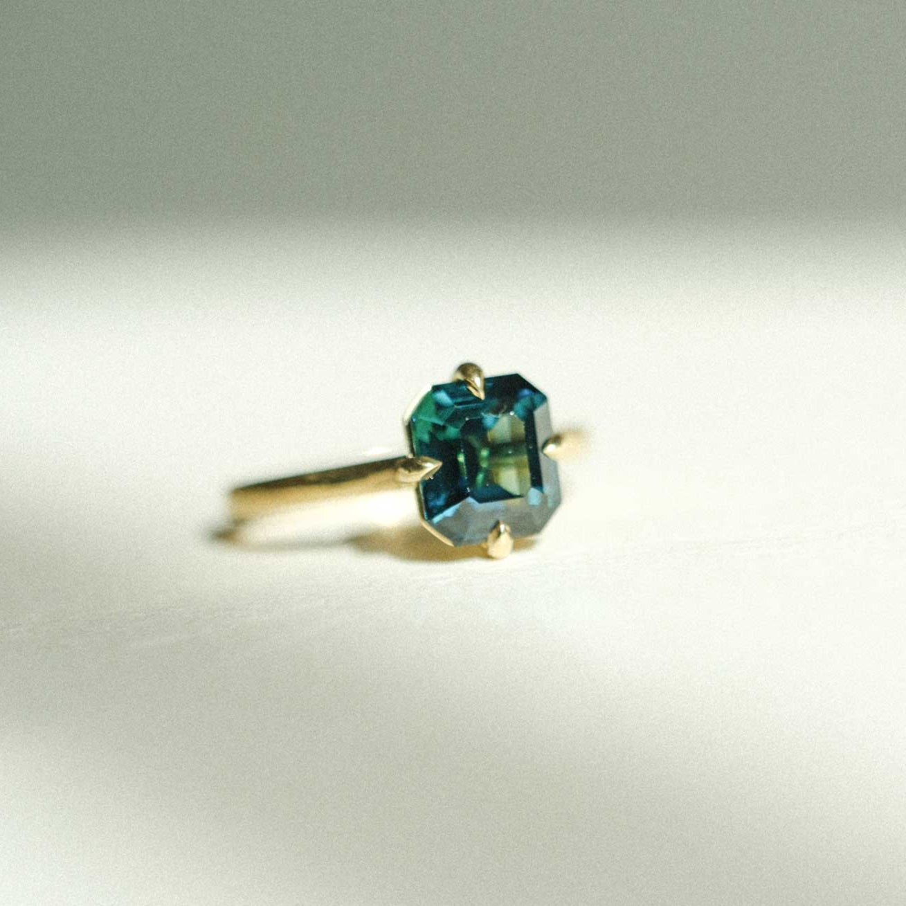 E.C.One MILA ethical teal sapphire engagement ring in recycled gold made in our London B Corp workshop