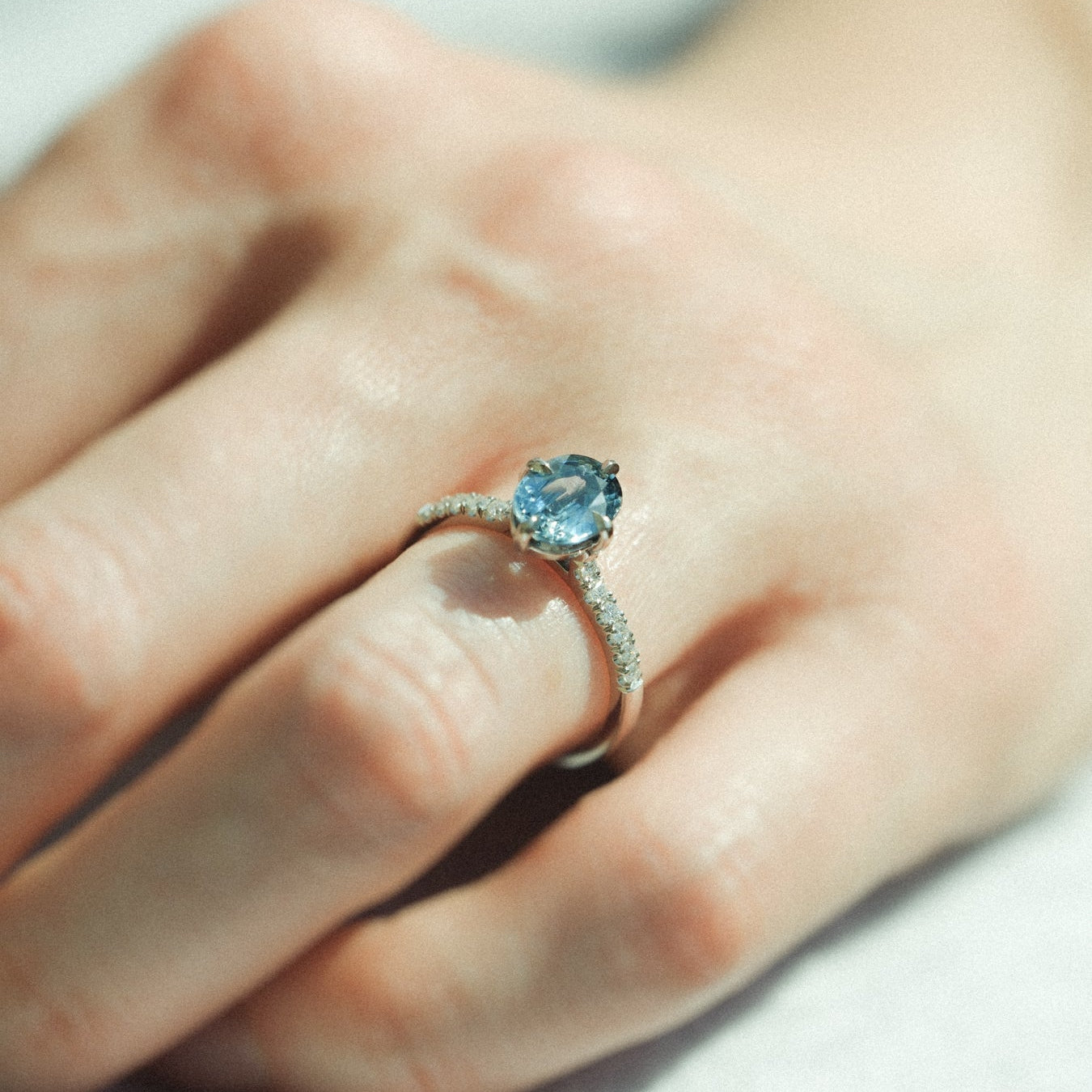 MILA Platinum Solitaire Ring with Oval Teal Sapphire and Diamond Shoulders