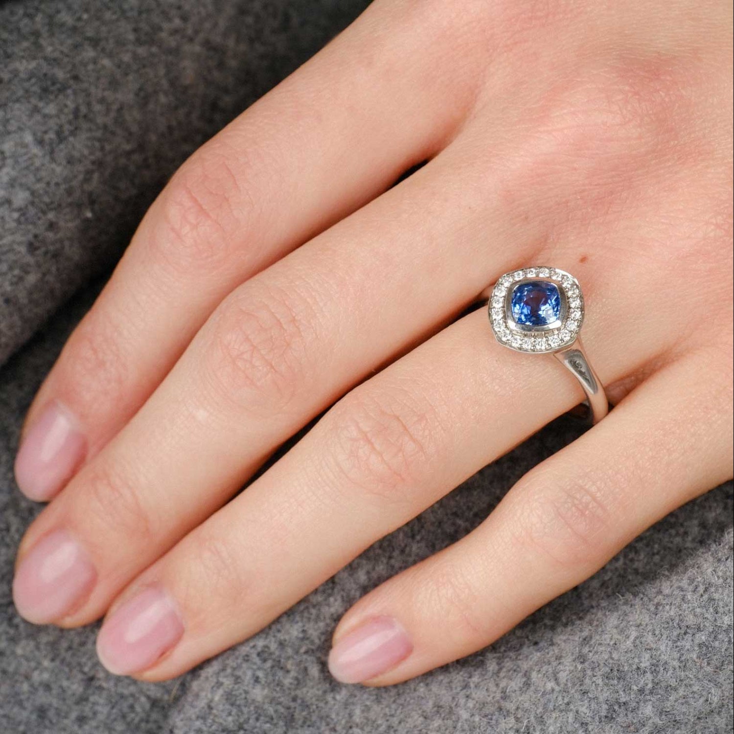 FRAME Platinum Cushion Blue Sapphire Ring with Diamond Halo by ethical jewellers E.C.One London, made in our B Corp London workshop