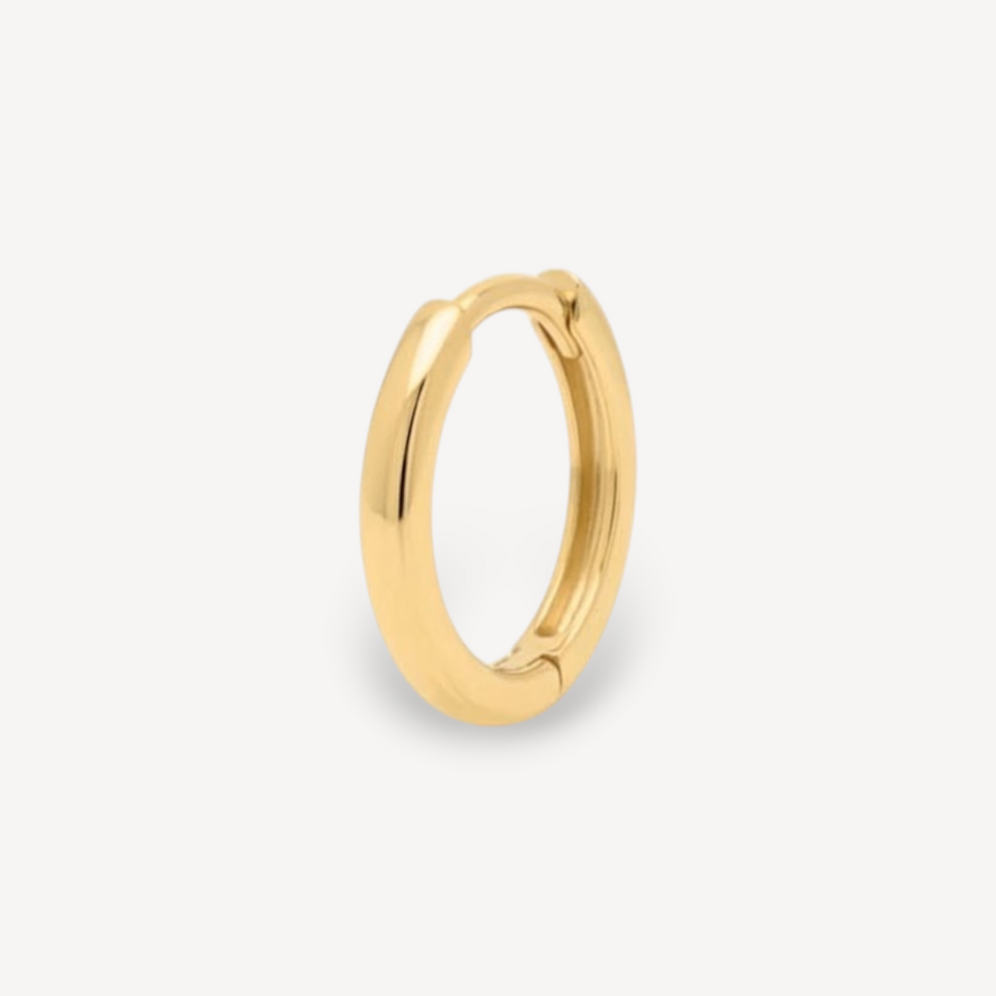 EC One single huggie hoop earring crafted from polished 18ct recycled yellow gold with a seamless hidden hinge.