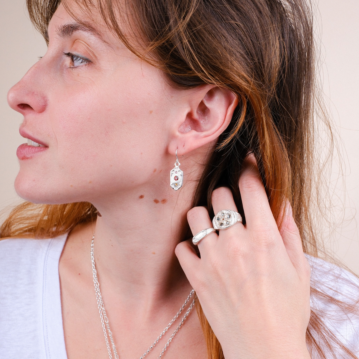 EC One Archer Window silver ring worn on a woman's hand, featuring a hand-carved textured design.