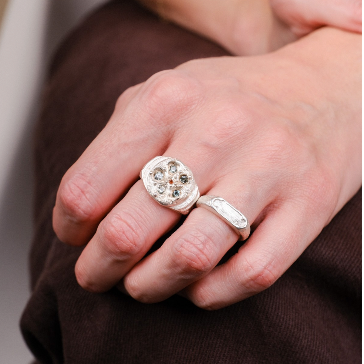 EC One Archer Window Ring in silver worn on a finger with a textured hand-carved finish