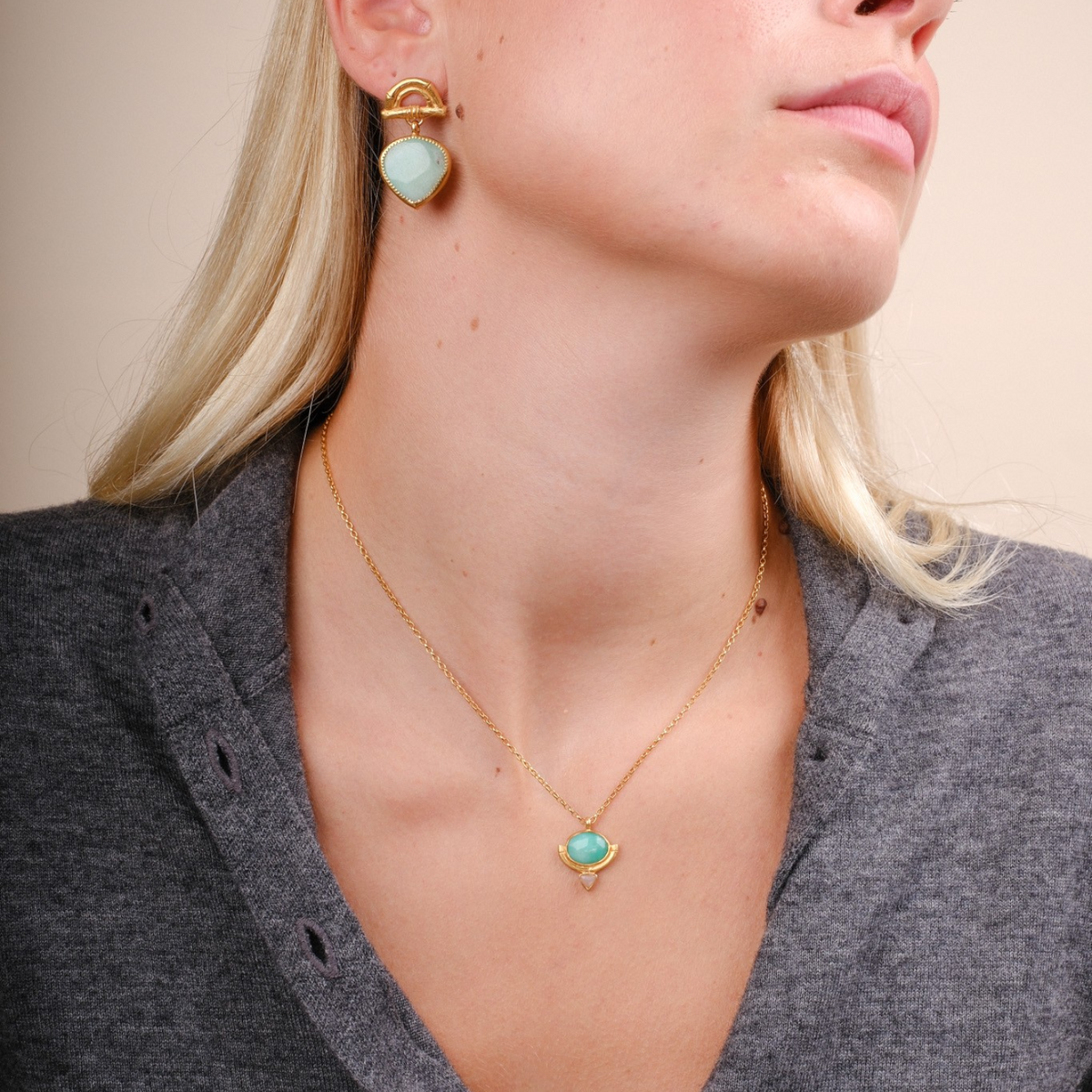EC One Rosita Bonita gold plated necklace featuring an oval chrysoprase and peach moonstone pendant on a model.
