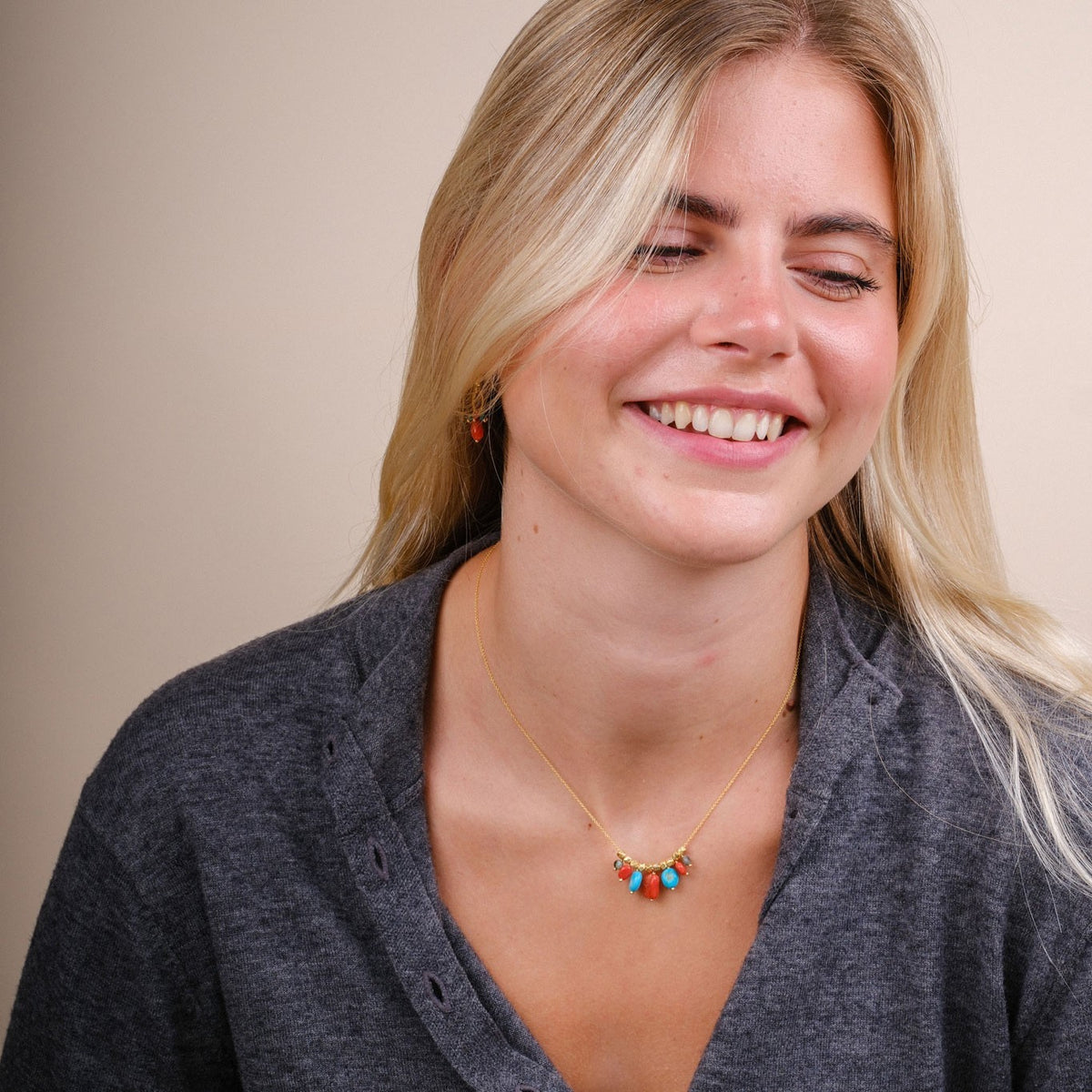 EC One Collette necklace featuring coral and turquoise beads on a gold plated recycled silver chain worn by a model