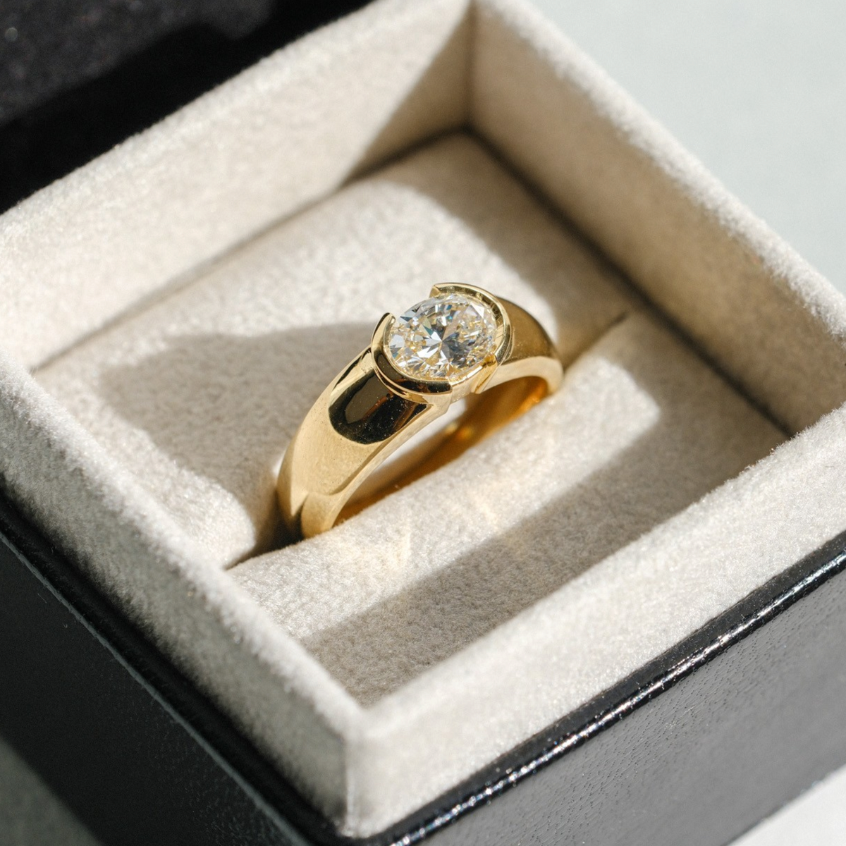 EC One EDIE engagement ring featuring an oval diamond in a chunky 18ct yellow gold demi-rub over setting in a box