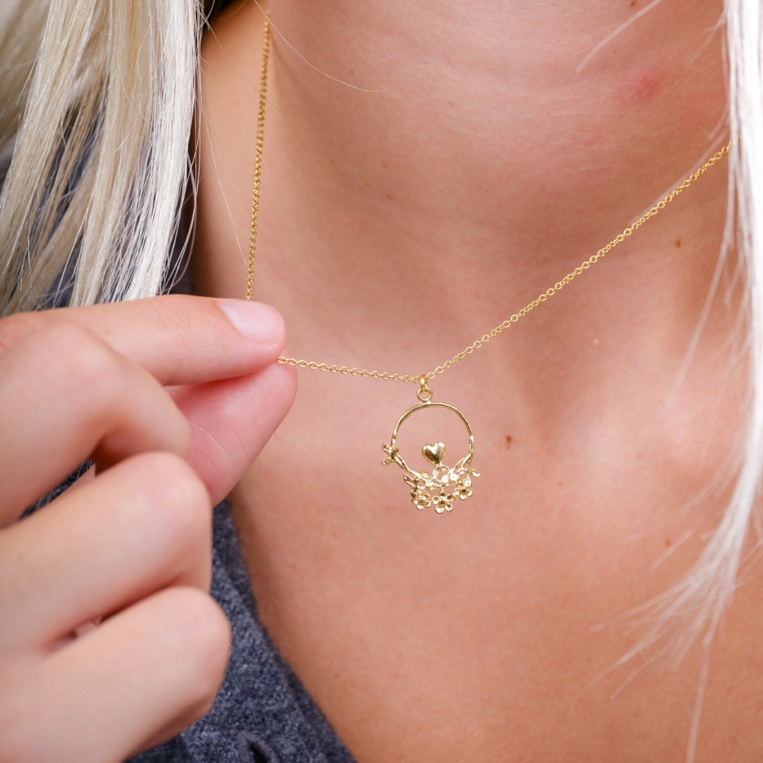 EC One 40th Anniversary gold plated necklace featuring a delicate loop with a heart, leaves, and flowers on a chain