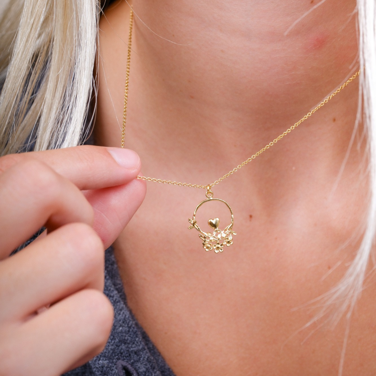 EC One 40th Anniversary gold plated necklace featuring a delicate loop with a heart, leaves, and flowers on a chain