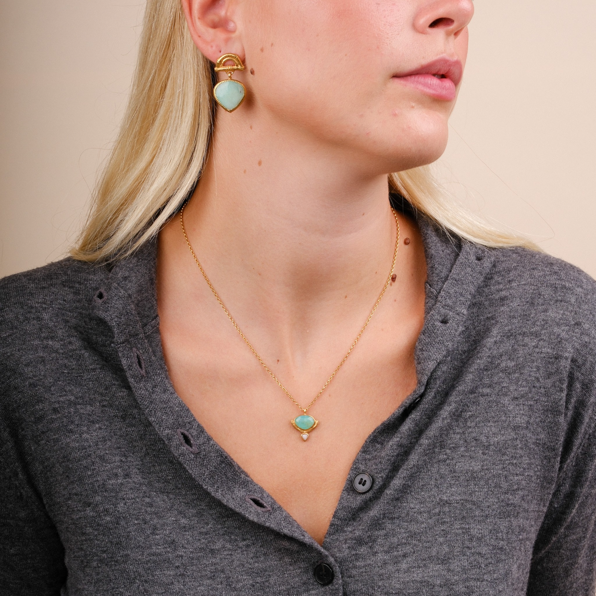 EC One Rosita Bonita gold plated mini bamboo hammock necklace with green and pink opal worn by a blonde model