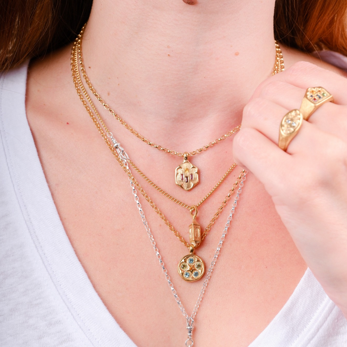 EC One layered pendant necklace featuring gold plated and silver chains with pink and blue gemstone charms