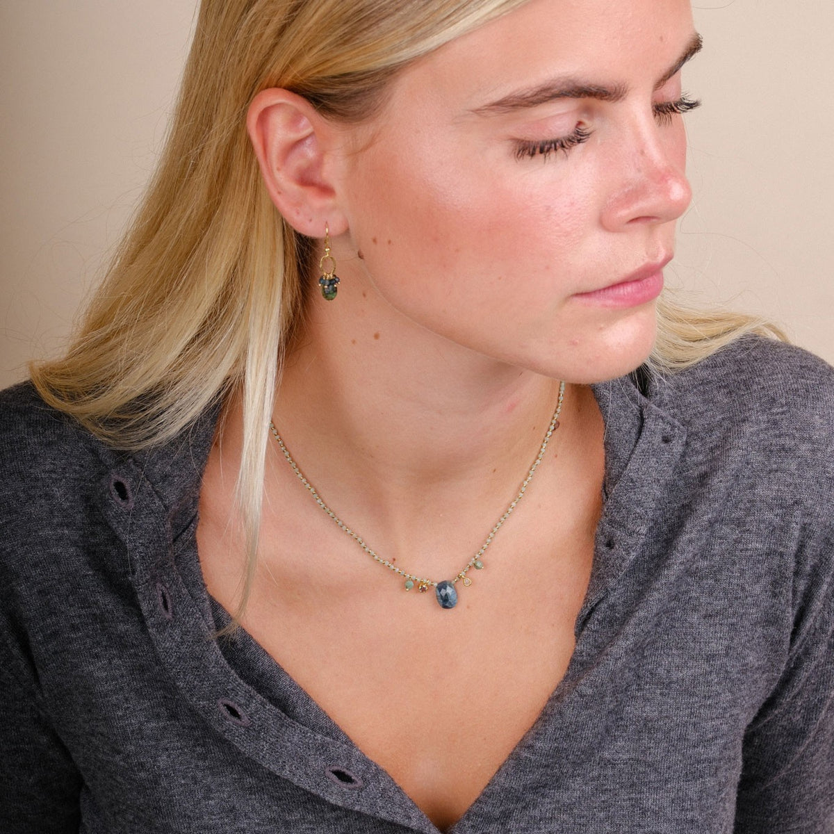 EC One MENTUCCIA necklace featuring emeralds, tourmaline, and gold plated silver beads worn by a blonde woman