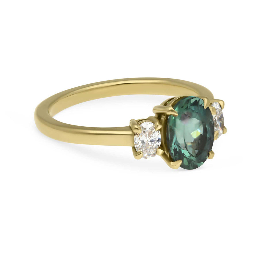 EC One OTTILIE Oval Teal Sapphire and Diamond Yellow Gold Trilogy Engagement Ring handmade in our London B Corp workshop