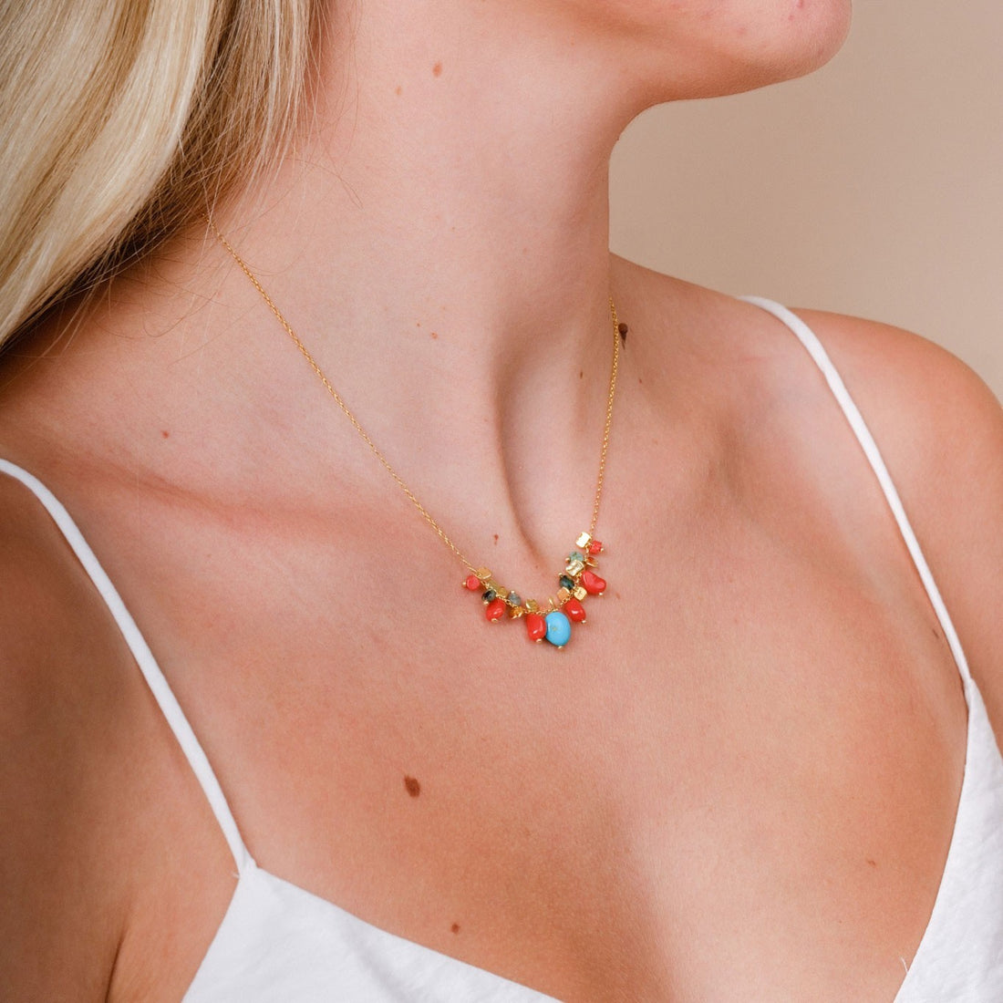 EC One PETALO necklace featuring coral and turquoise beads on a gold plated recycled silver chain worn on a model