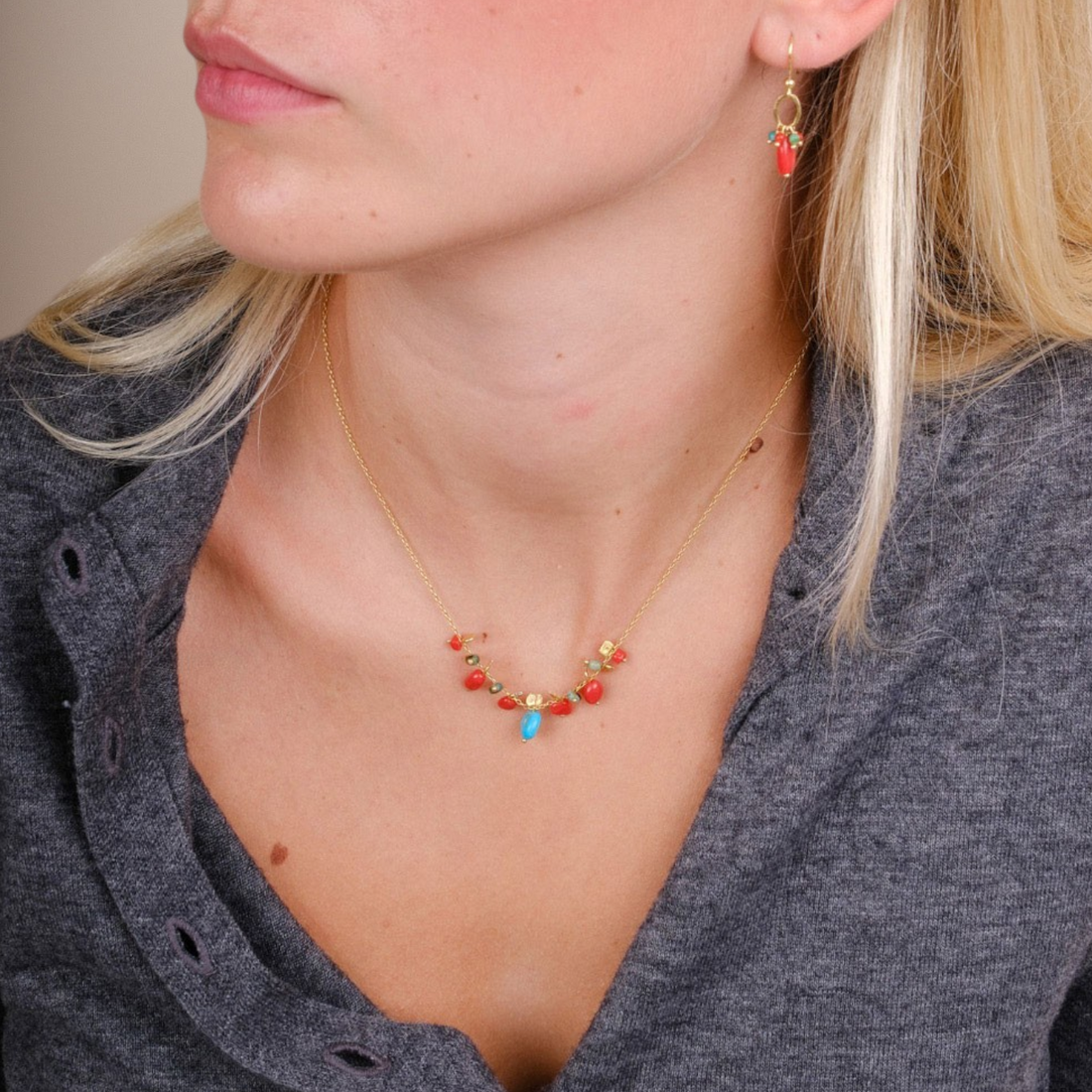 EC One PETALO necklace featuring coral and turquoise beads on a gold plated recycled silver chain worn by a model