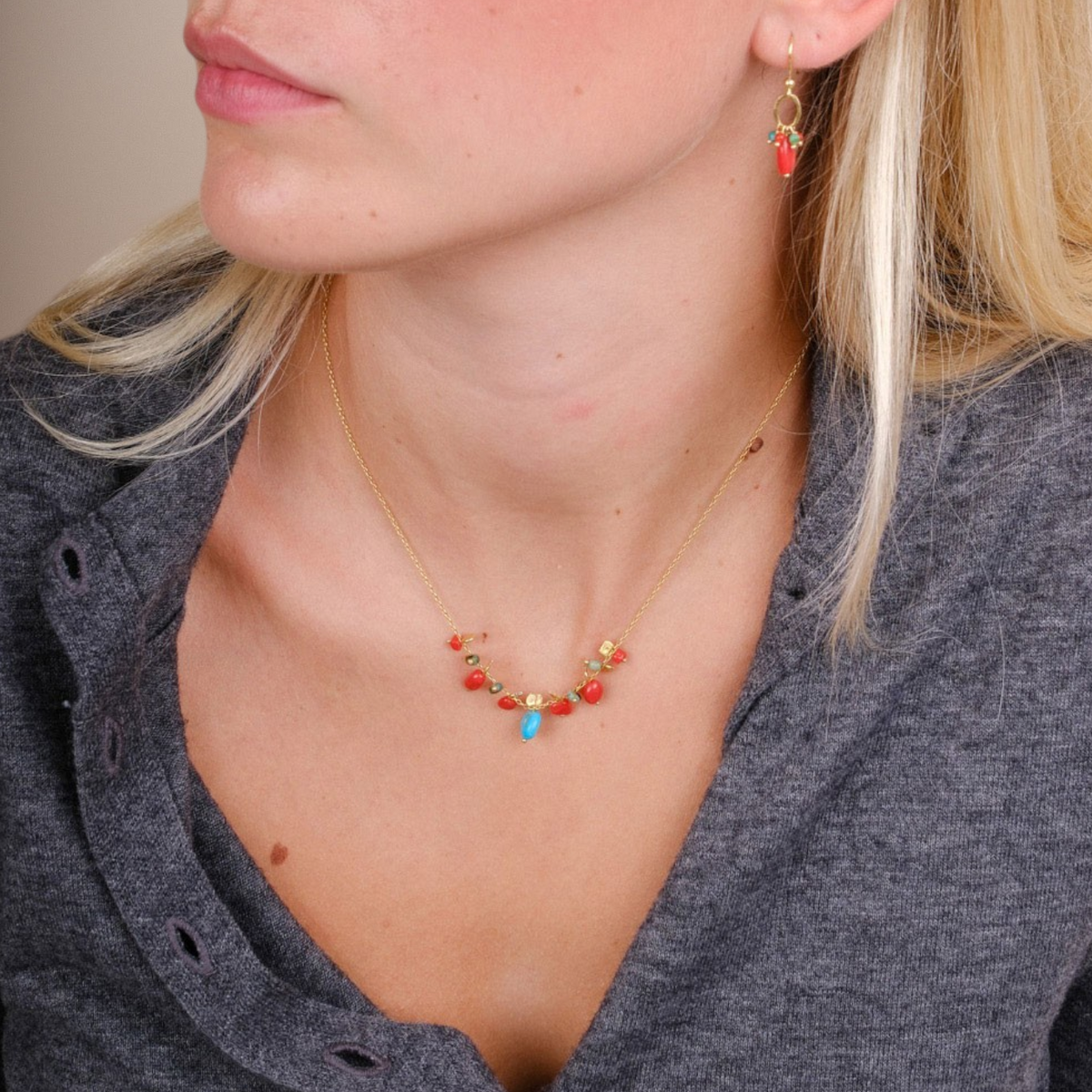 EC One PETALO necklace featuring coral and turquoise beads on a gold plated recycled silver chain worn by a model