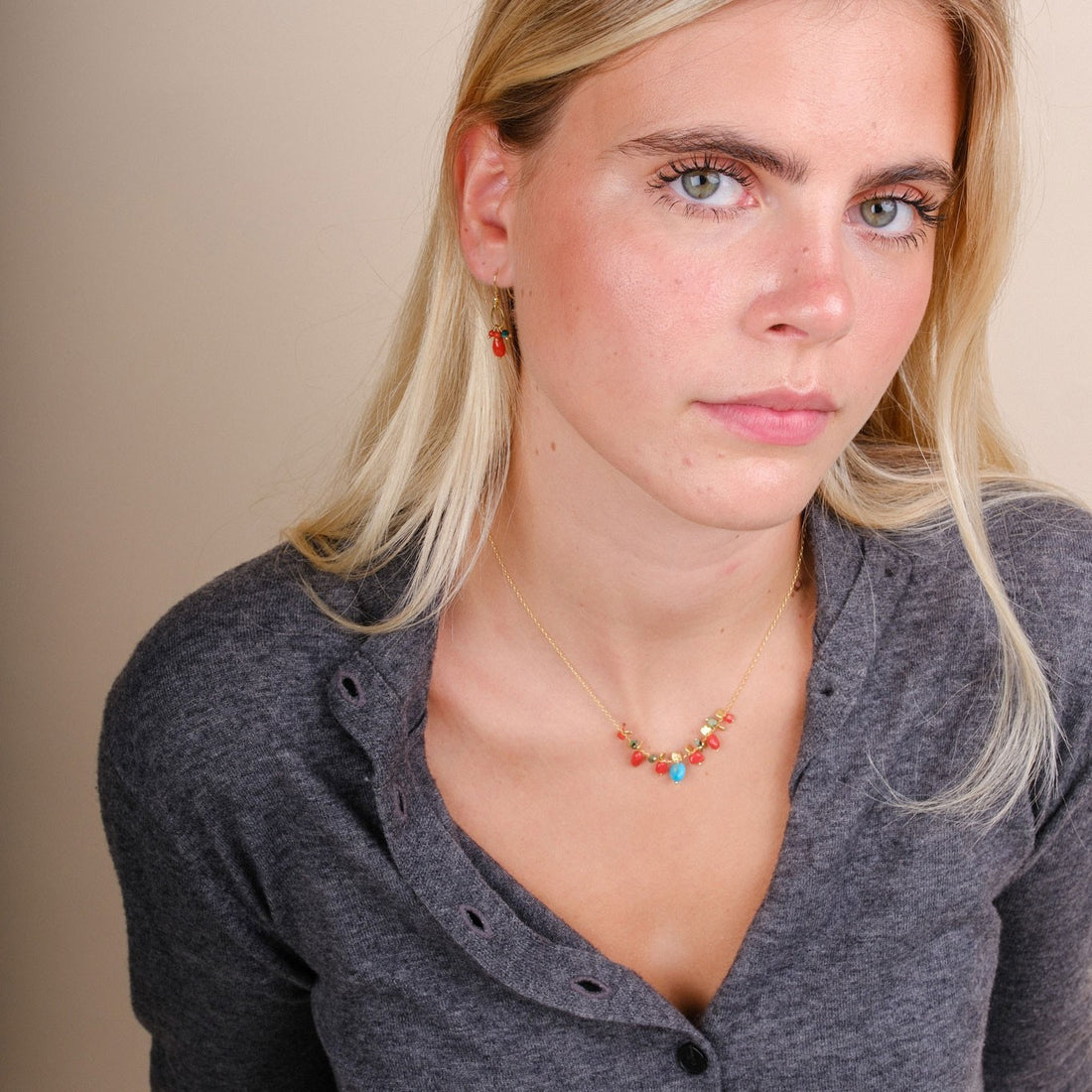 EC One PETALO necklace featuring coral and turquoise beads on a gold plated recycled silver chain worn by a model