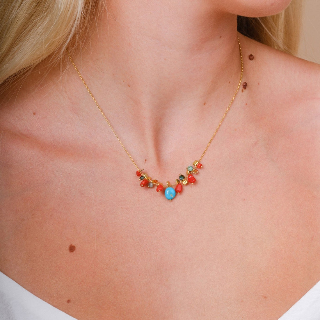 EC One PETALO necklace featuring coral and turquoise beads on a gold plated recycled silver chain worn on a neck
