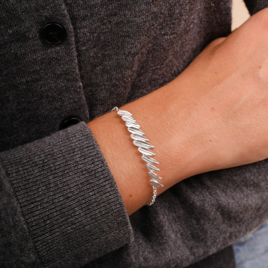 EC One Phoenix Plume bracelet in sterling silver featuring a delicate feather-inspired design on a wrist