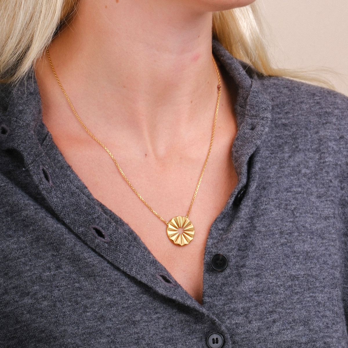EC One Polaris radial necklace in gold plated recycled silver worn by a woman with matching stud earrings
