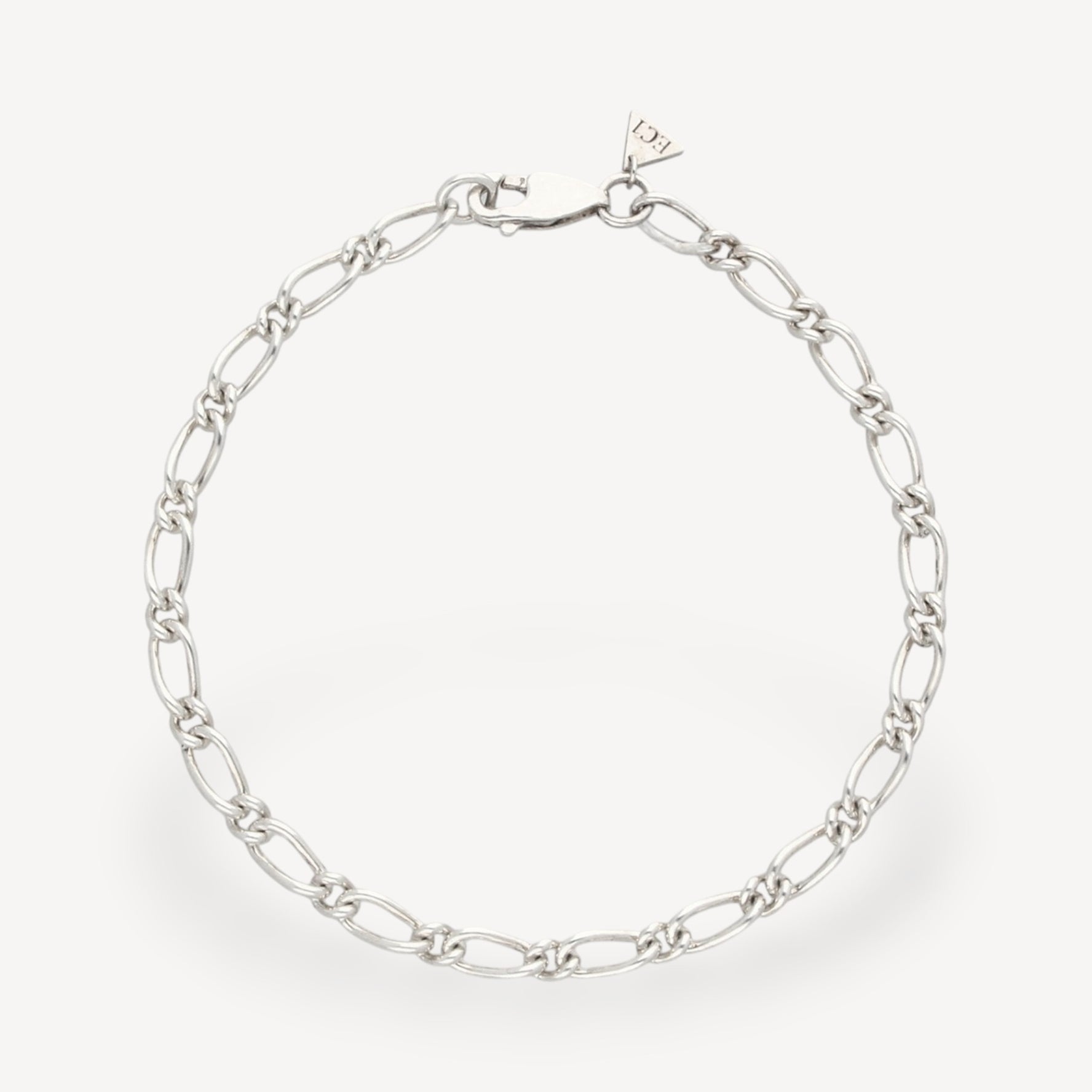 EC One 4mm wide recycled silver figaro chain bracelet with a lobster clasp closure on a plain background.
