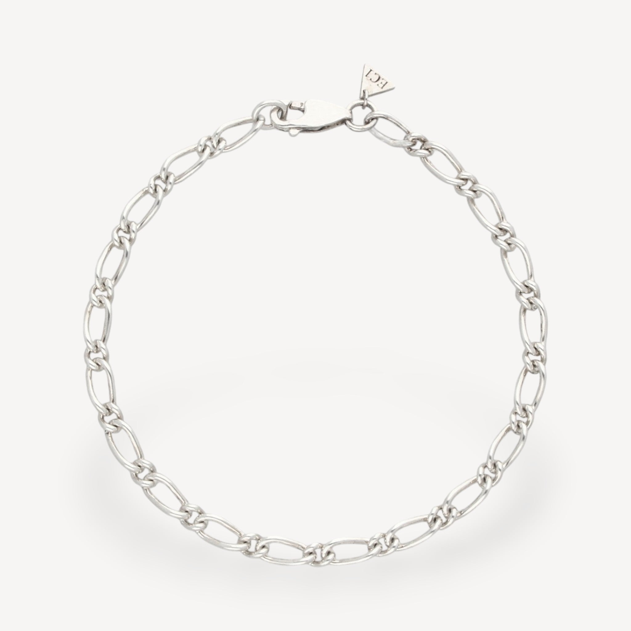 EC One 4mm wide recycled silver figaro chain bracelet with a lobster clasp closure on a plain background.