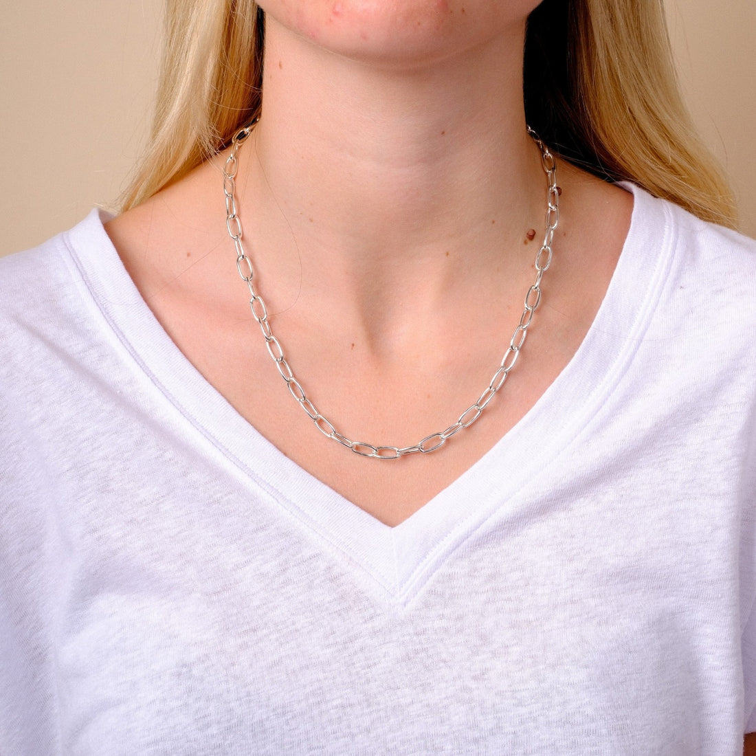EC One heavy recycled silver oval link necklace worn on a model in a white v-neck t-shirt