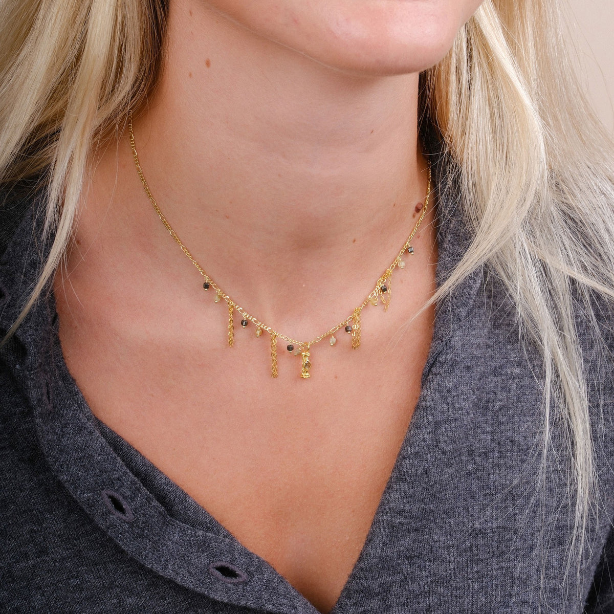 EC One RIFRANGE necklace featuring gold plated recycled silver, pyrite, green garnet, and polki diamonds on a model.