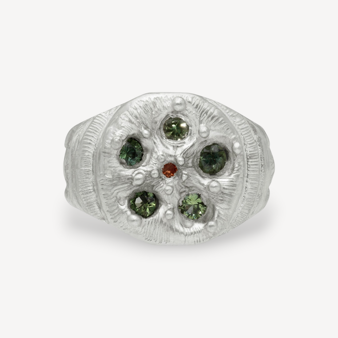 EC One Rose Window ring in textured silver featuring five green sapphires and a central orange gemstone