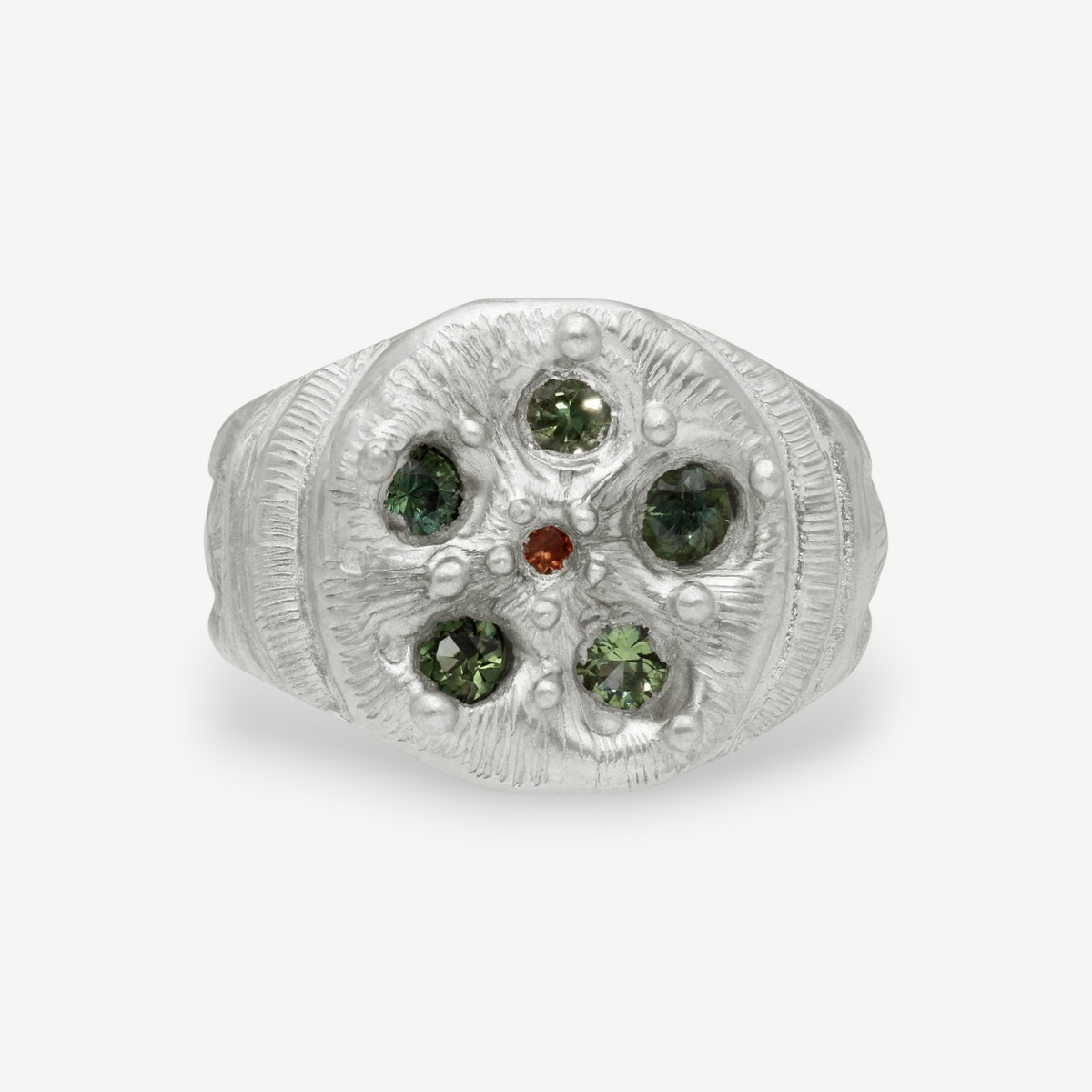 EC One Rose Window ring in textured silver featuring five green sapphires and a central orange gemstone