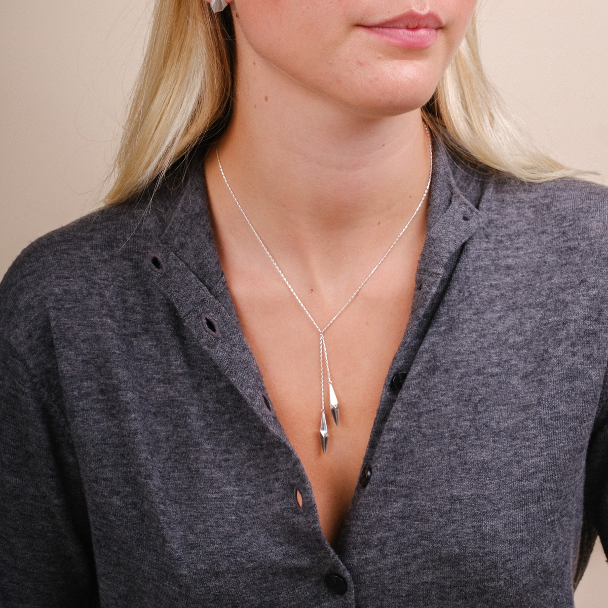 EC One Shard double drop necklace in recycled silver worn on a model, featuring two hand-carved faceted pendants.