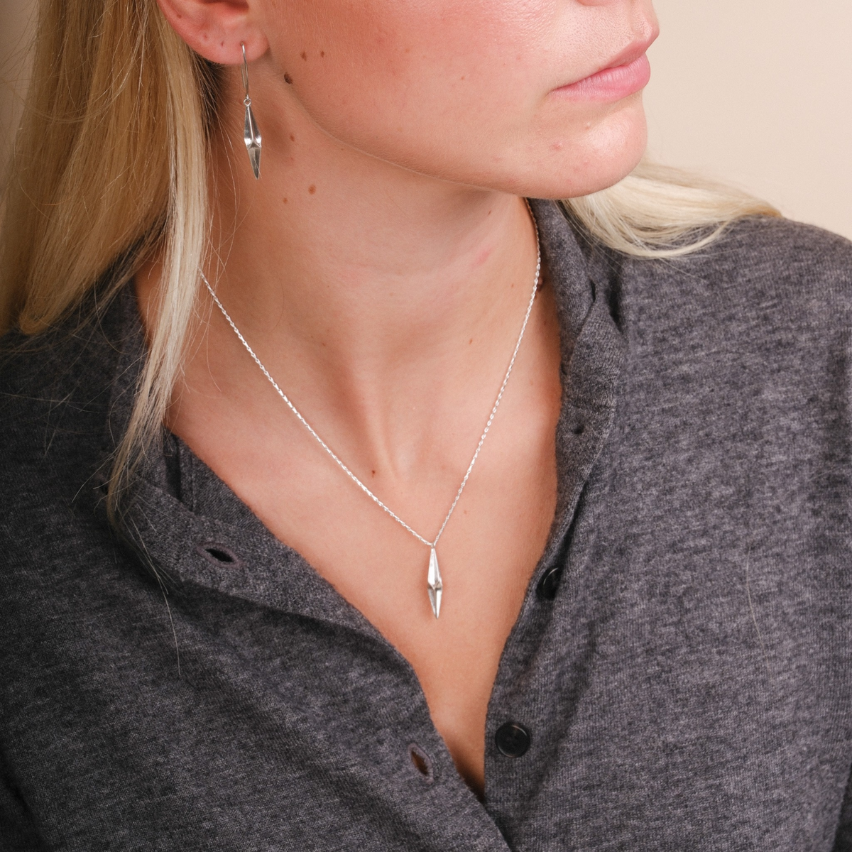 EC One Shard single drop necklace in recycled silver worn by a woman with matching shard drop earrings