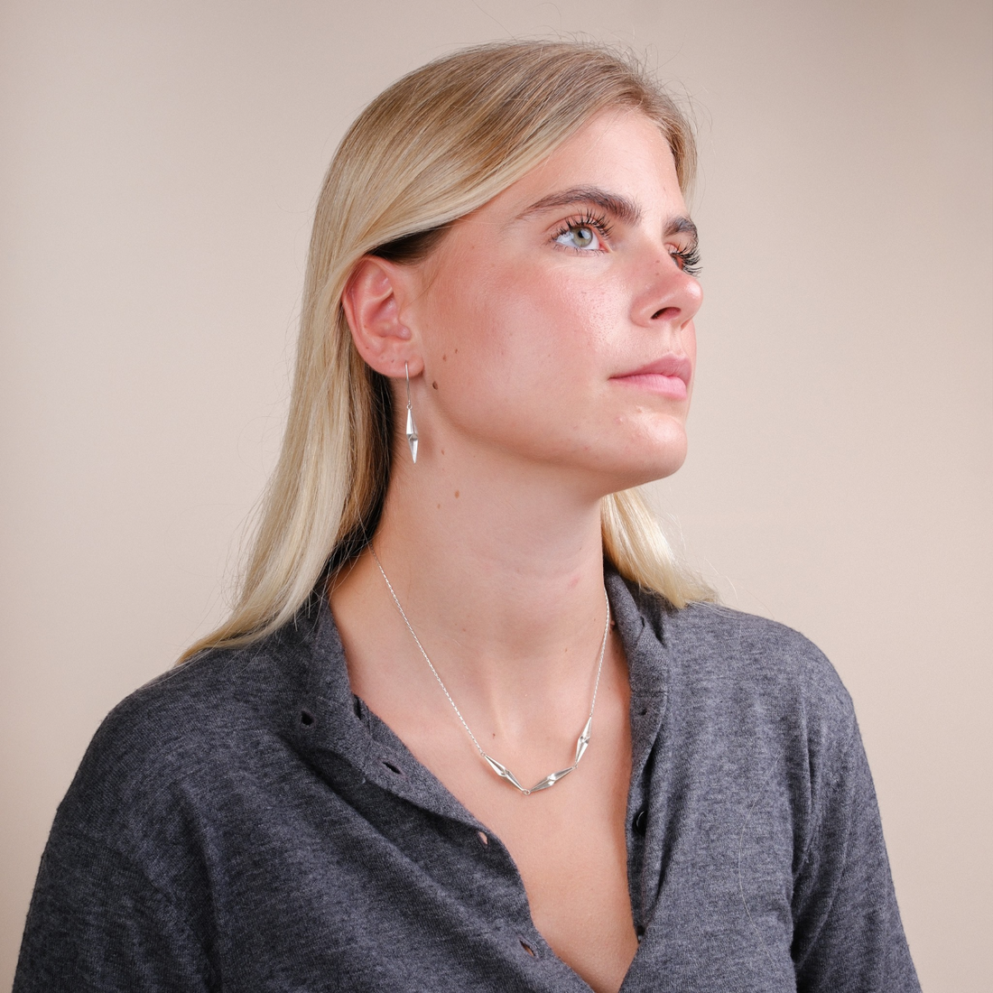EC One Shard Triplet necklace in recycled silver with three faceted shards, worn by a blonde model.