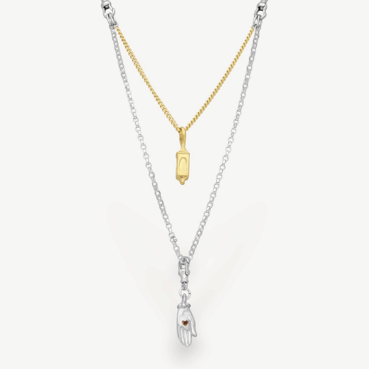 EC One interchangeable silver and gold plated chain necklace featuring a small lantern and hand charm with a red gem.