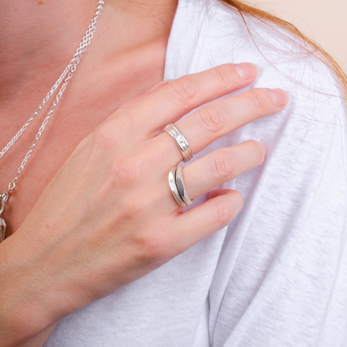 EC One silver skinny signet ring worn on a finger with a textured hand-carved finish