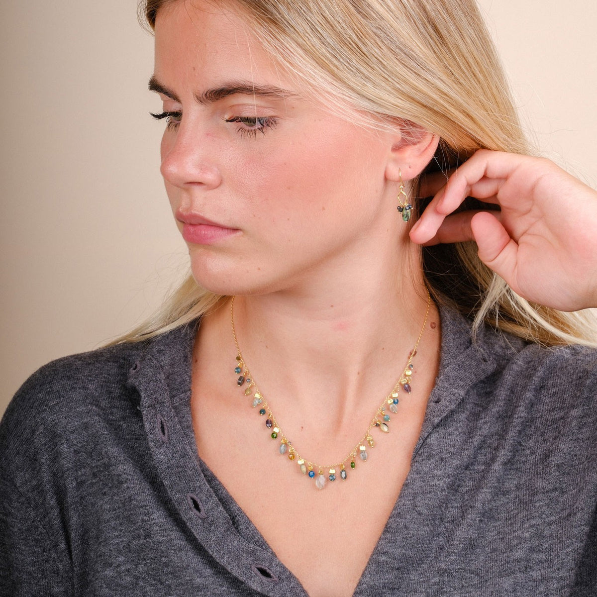EC One Stellina necklace featuring blue apatite, green garnet, and iolite beads on gold plated recycled silver chain