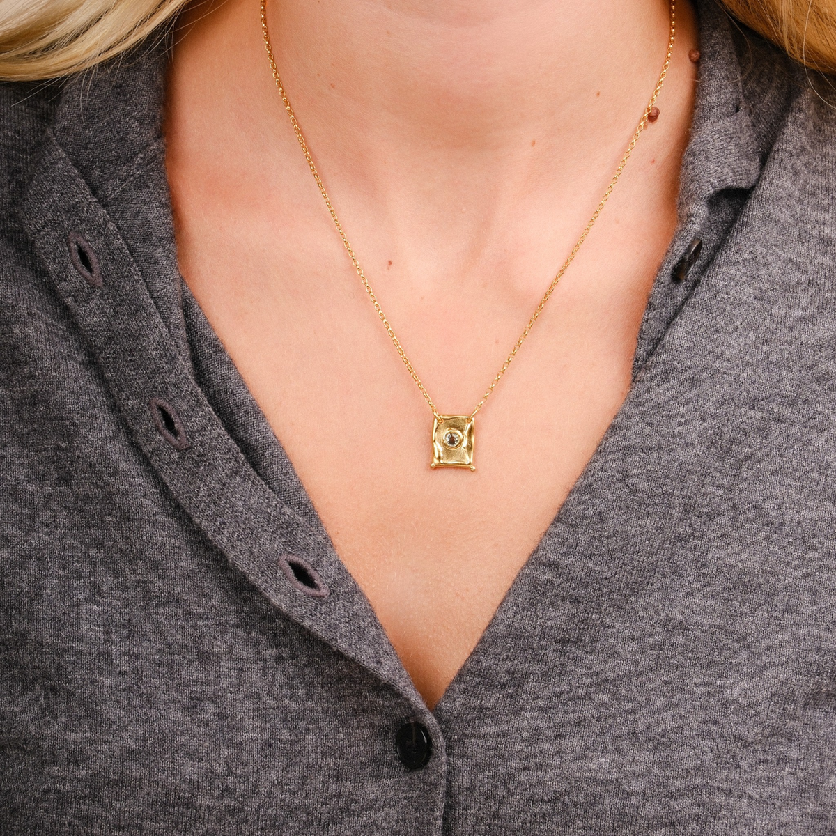 EC One TABLET pendant featuring a round green sapphire set in gold plated recycled silver on a delicate gold chain.