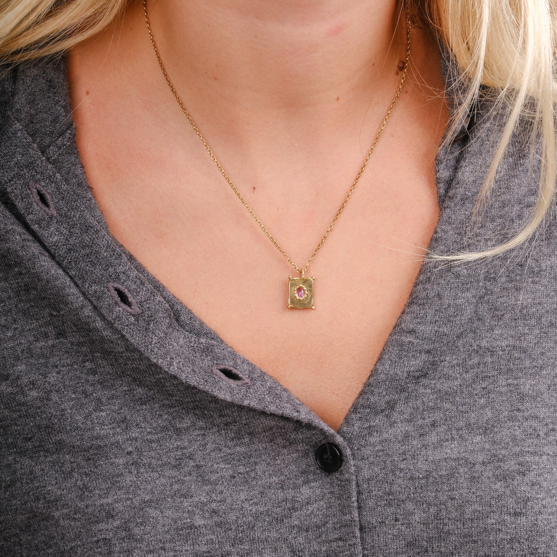 EC One TABLET mini pendant in gold plated recycled silver with a pink sapphire on a delicate chain worn on a neck