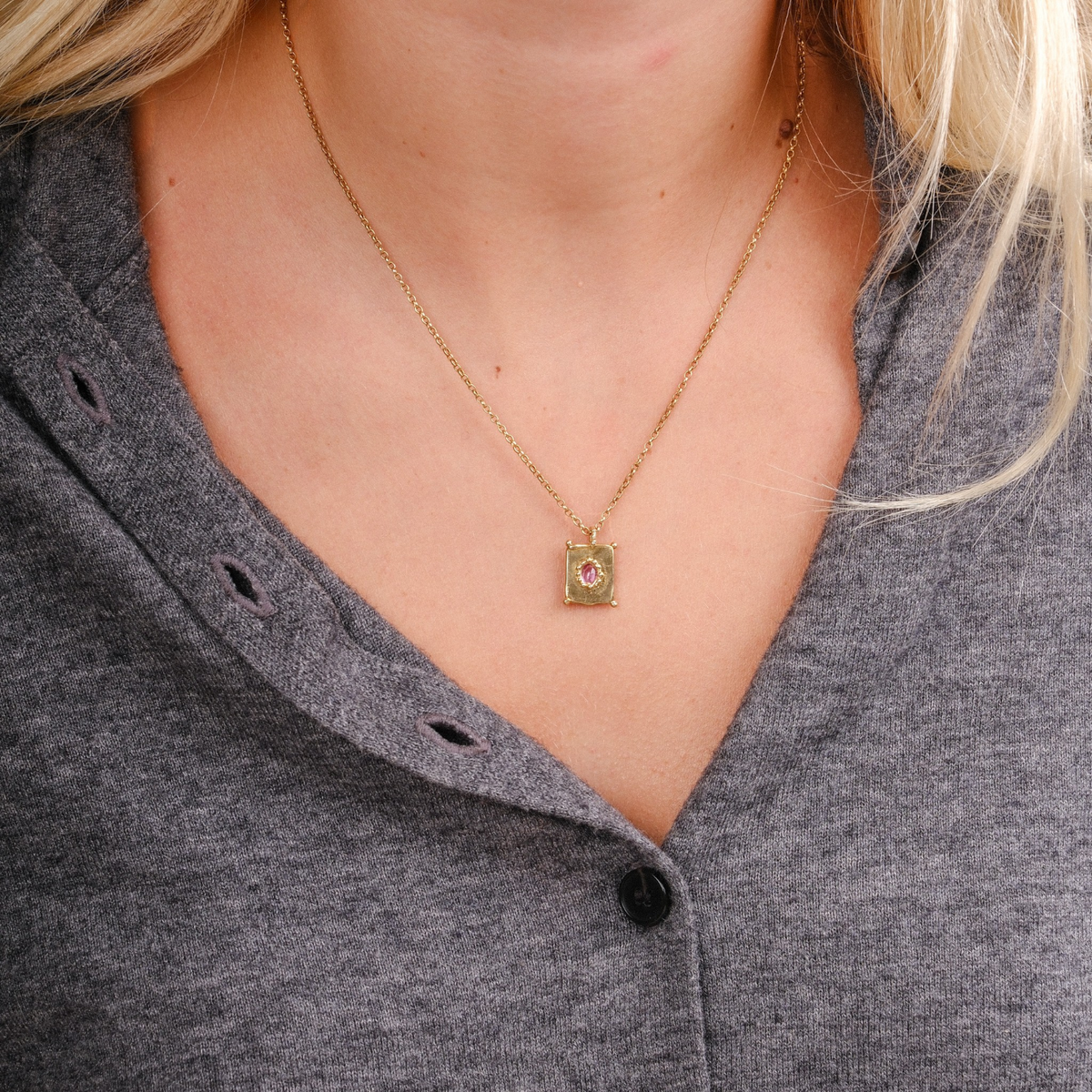 EC One TABLET mini pendant in gold plated recycled silver with a pink sapphire on a delicate chain worn on a neck