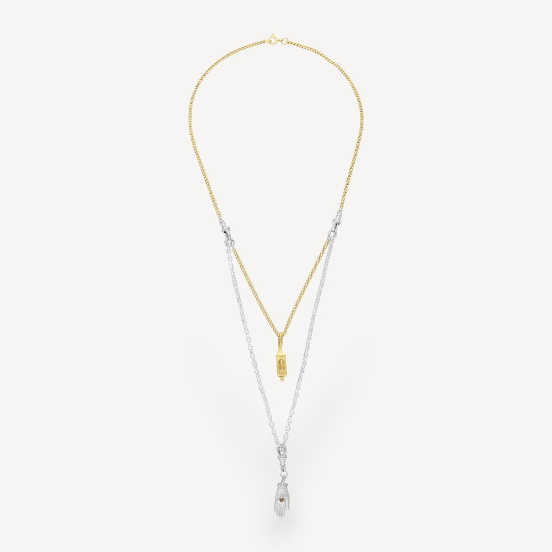 EC One interchangeable two-tone necklace featuring a gold chain with lantern charm and silver chain with hand charm