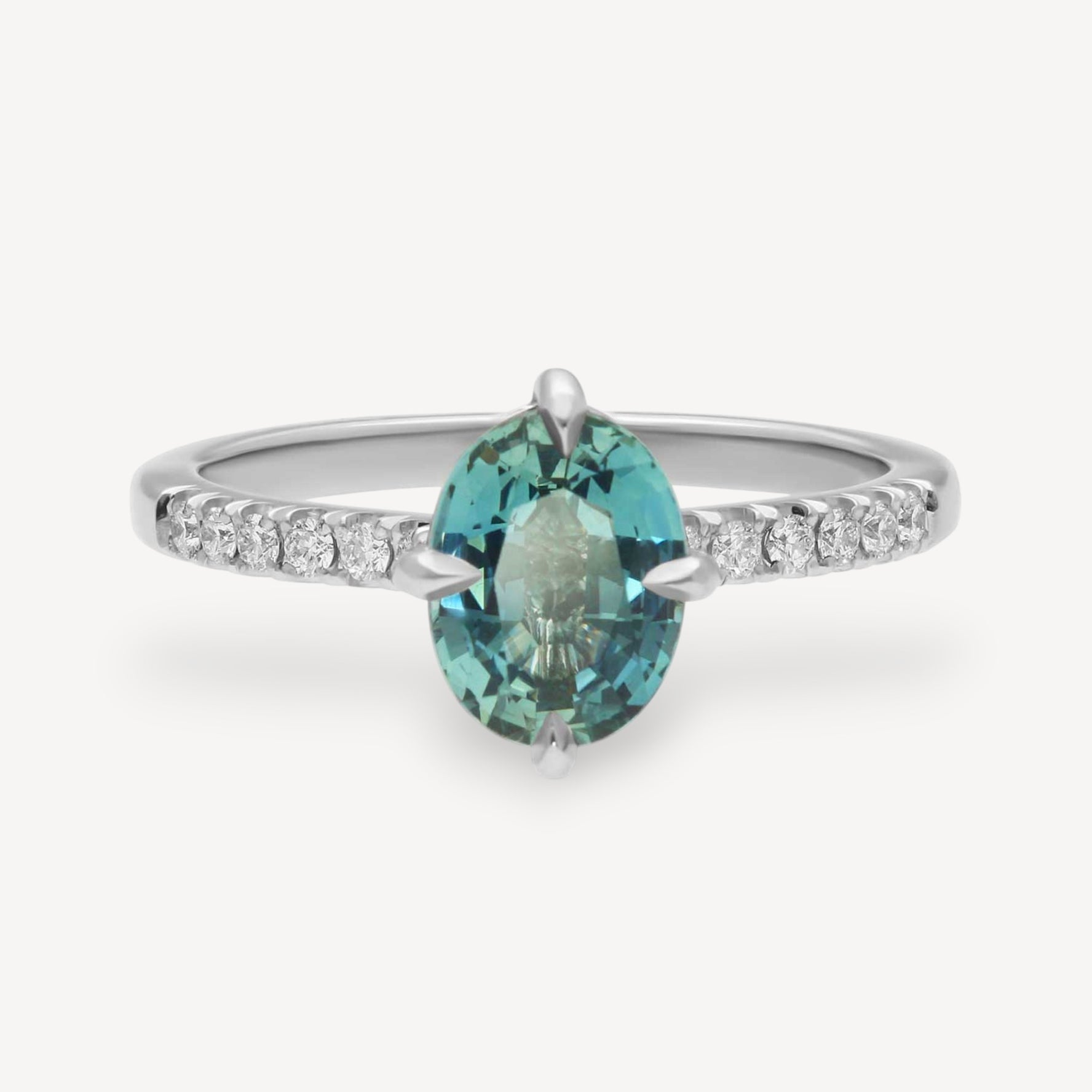 MILA Platinum Solitaire Ring with Oval Teal Sapphire and Diamond Shoulders
