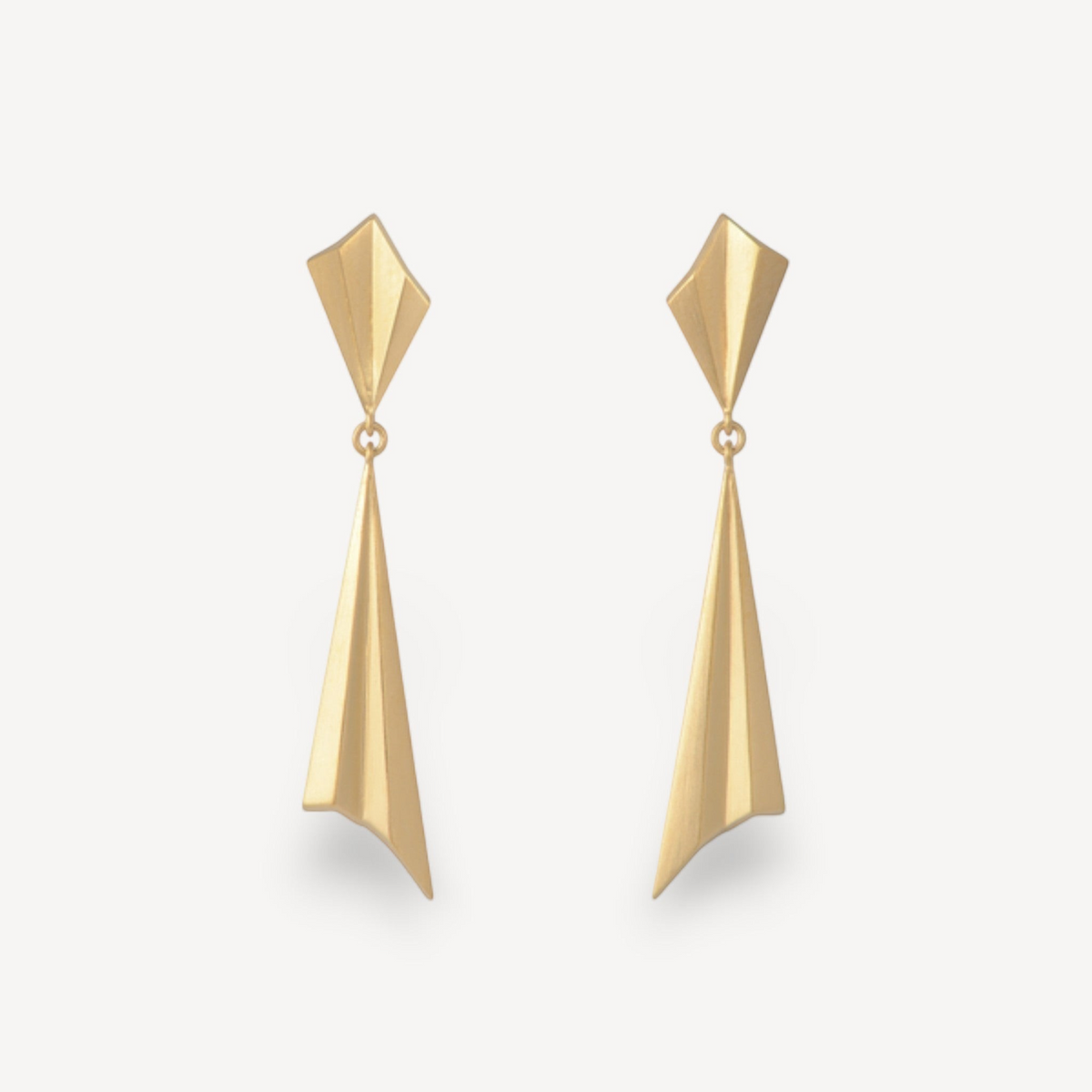 EC One gold plated geometric drop earrings with long pleated spikes and pleated studs on a light background