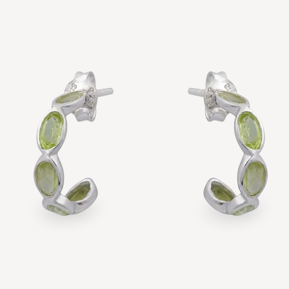 EC One Luna hoop earrings in silver featuring oval faceted peridot gemstones for a fresh green sparkle.