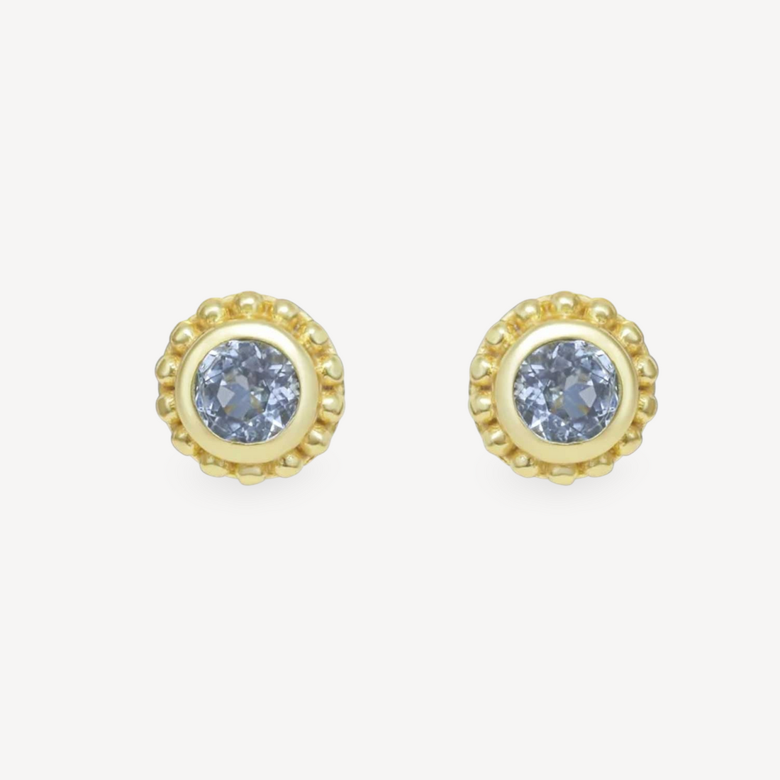 EC One SUNBEAM stud earrings featuring round blue topaz gemstones set in gold plated silver with beaded edges.