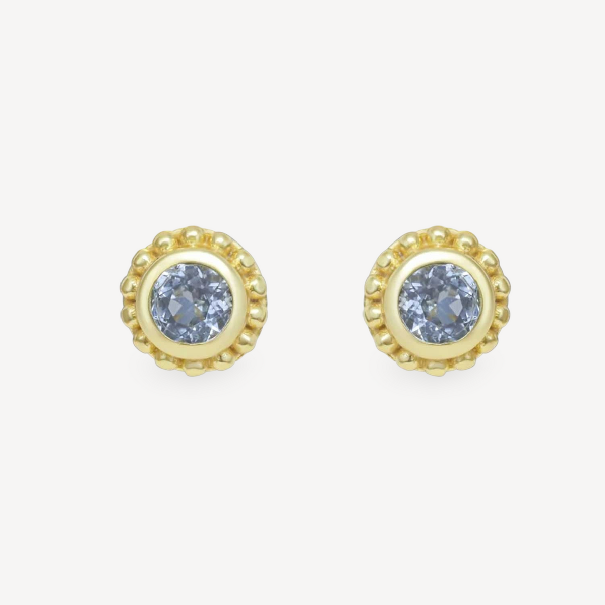EC One SUNBEAM stud earrings featuring round blue topaz gemstones set in gold plated silver with beaded edges.