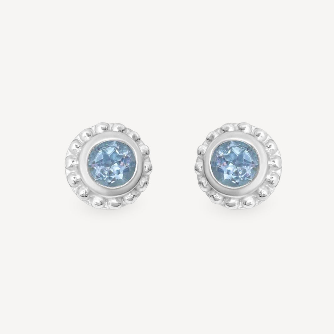 EC One SUNBEAM stud earrings featuring round blue topaz gemstones set in textured silver frames.
