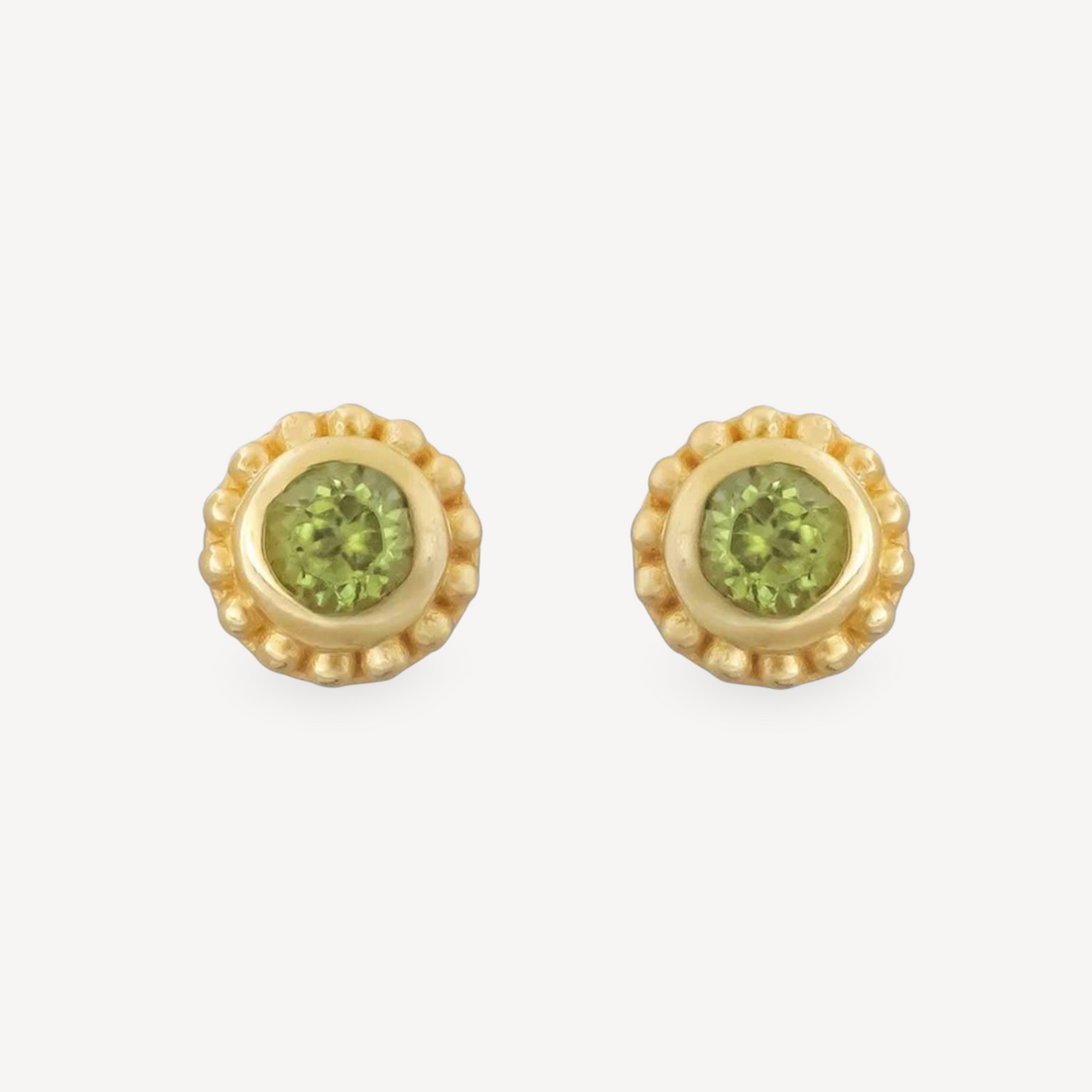EC One SUNBEAM peridot stud earrings featuring round green gemstones set in gold plated silver with beaded edges.